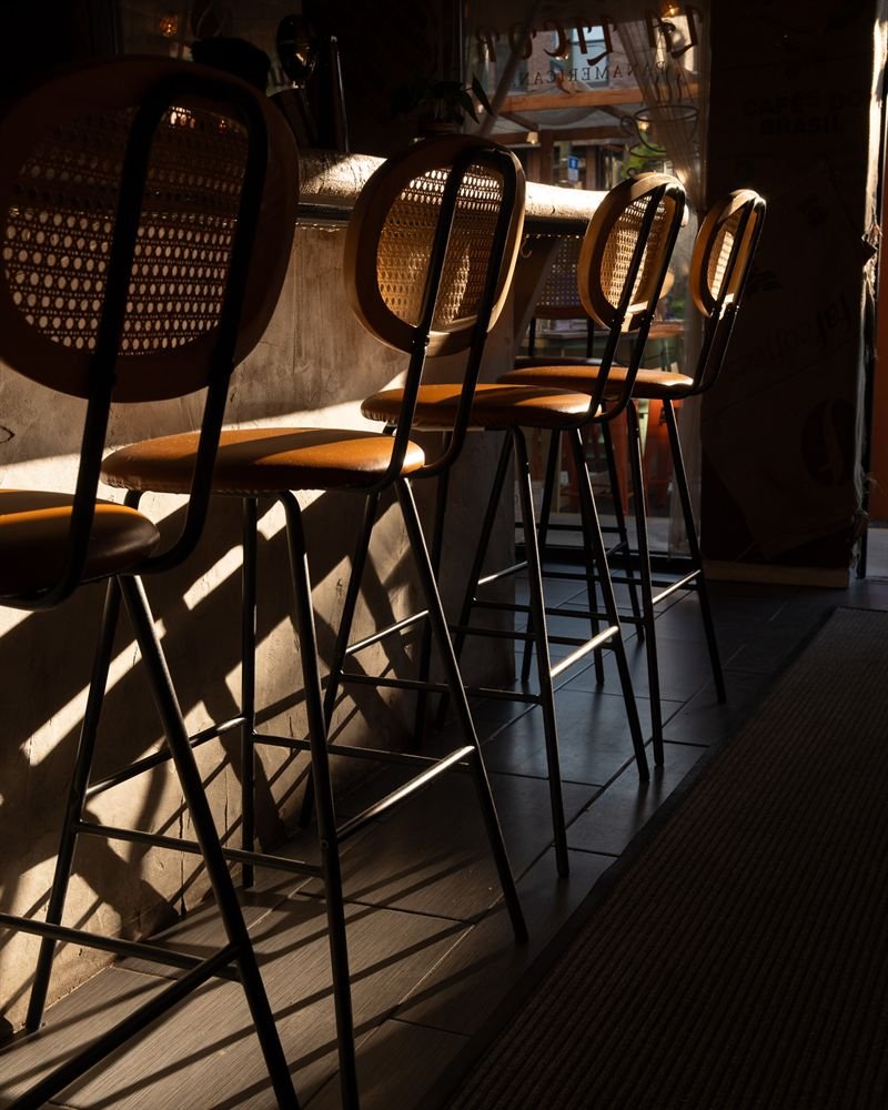 Bar stools at La Licor in late-afternoon sun, during daily happy hour