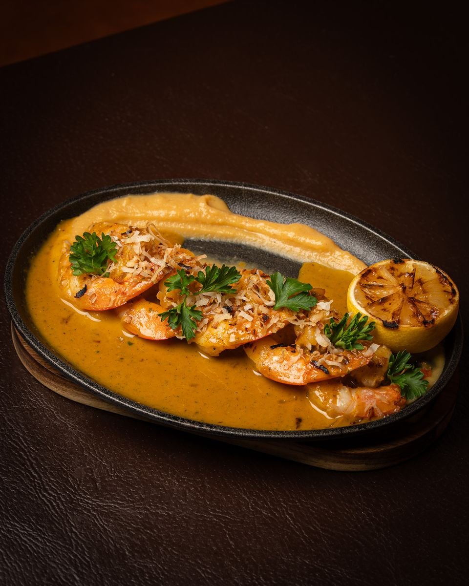 Shrimp in a golden sauce with grilled lemon